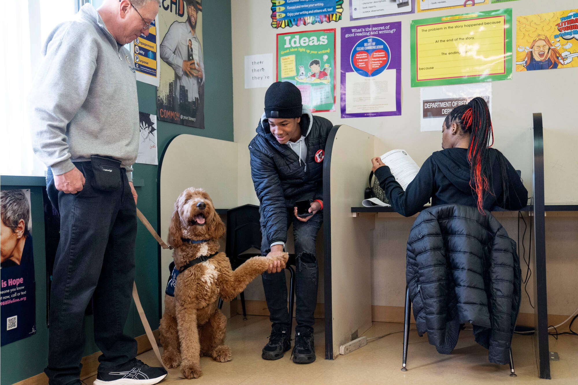 student doing a trick with Beau the dog